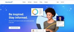 BuzzSumo homepage hero banner with the headline 'Be inspired. Stay informed.' alongside floating content engagement cards and a woman using a laptop.
