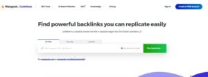 Screenshot of the Mangools LinkMiner homepage featuring the headline 'Find powerful backlinks you can replicate easily' with an input field to check domain or URL backlinks and a call-to-action button to create a free account.