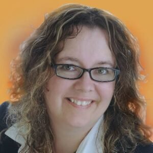 Headshot portrait of search quality and Google algorithm expert Dr. Marie Haynes smiling with glasses and curly brown hair against an orange gradient background.