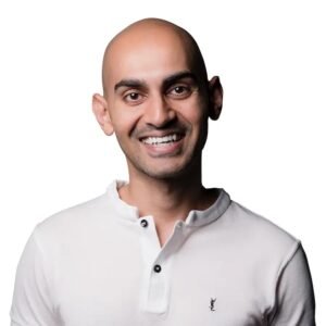 Headshot portrait of digital marketing and SEO entrepreneur Neil Patel smiling in a white polo shirt against a clean background.