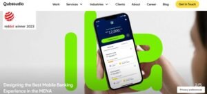 Screenshot of the Qubstudio homepage displaying a Red Dot Award 2022 badge, a 3D lime-green letter graphic, a mobile banking UI mockup on a smartphone, and the headline 'Designing the Best Mobile Banking Experience in the MENA'.
