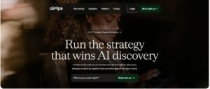 AirOps homepage hero section featuring the headline 'Run the strategy that wins AI discovery', an email input form with a green 'Work with us' button, and a background photograph of a professional reviewing a digital device.